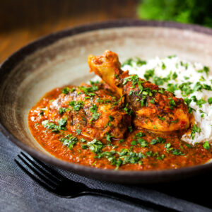Indian chicken (murgh) kolhapuri curry served with basmati rice and coriander.