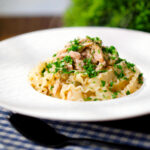 Garlic, lemon and caper chicken piccata pasta garnished with fresh parsley.