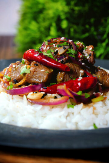 Chinese Xinjiang lamb stir fry with cumin, dried chillies and red onion served with rice.