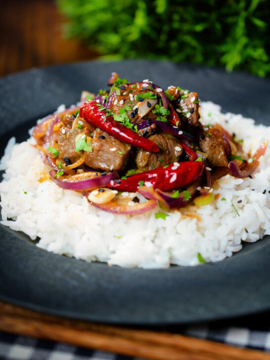 Chinese Xinjiang lamb stir fry with cumin, dried chillies and red onion served with jasmine rice.