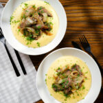 Overhead Fegato alla Veneziana (Italian fried liver and onions) served with polenta.