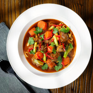 M&igrave; B&ograve; Kho (mi bo kho), Vietnamese beef and egg noodle stew with carrots and spring onions.