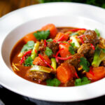 M&igrave; B&ograve; Kho, Vietnamese beef and egg noodle stew with carrots and spring onions.