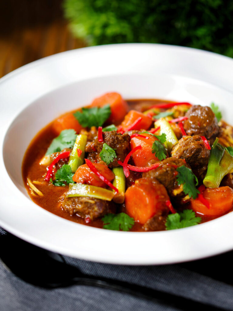 Mì Bò Kho, Vietnamese beef and egg noodle stew with carrots and spring onions.