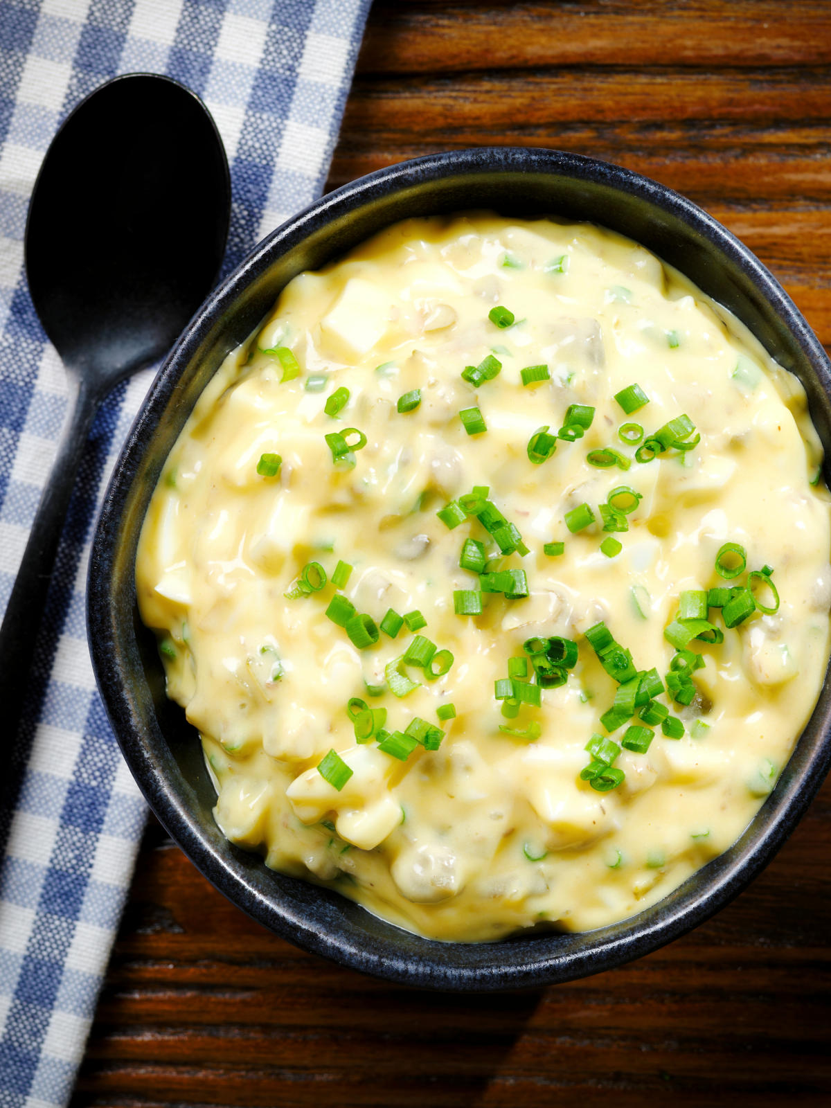 Overhead French sauce gribiche garnished with snipped chives.
