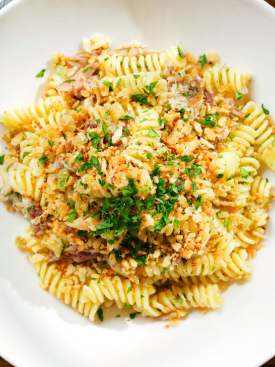 Close-up overhead smoked mackerel pasta (fusilli) with chilli and a lemon crumb.