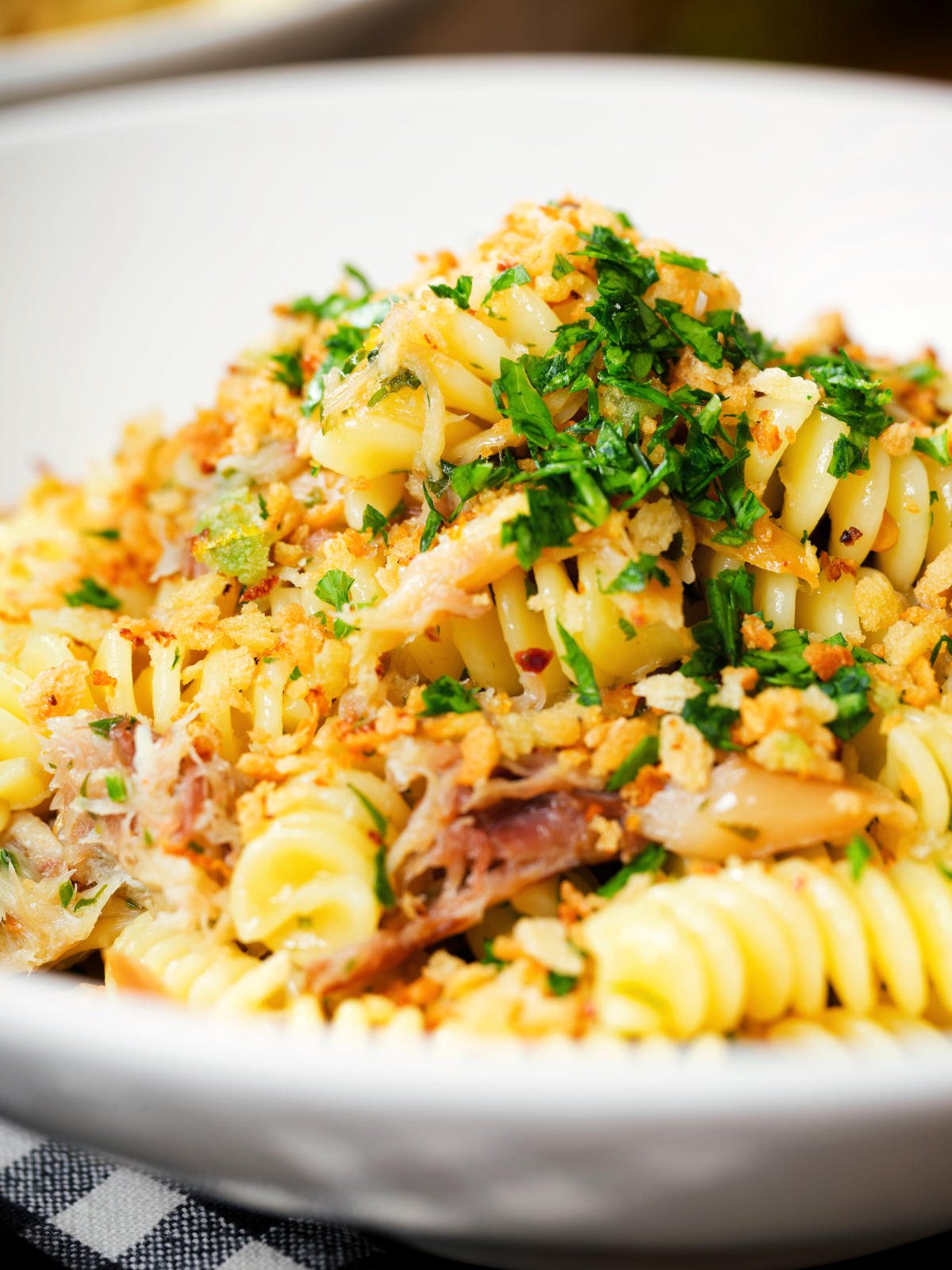Close-up smoked mackerel pasta (fusilli) with chilli and a lemon crumb.