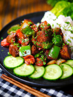 Vietnamese shaking beef (bò lúc lắc) served with cucumber, jasmine rice and lettuce.