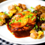 Baked Hawaiian chicken breast with pineapple huli huli sauce and crushed new potatoes.