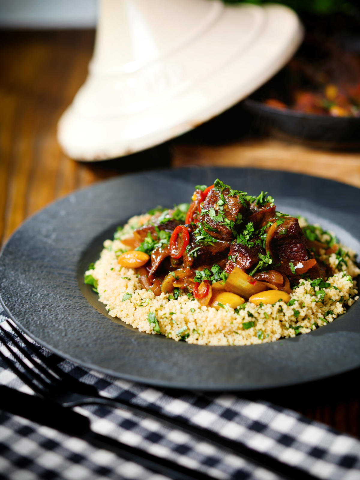 Harissa beef tagine with prunes and almonds served with buttered couscous.