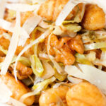 Close-up pan fried cabbage and walnut gnocchi with balsamic vinegar.