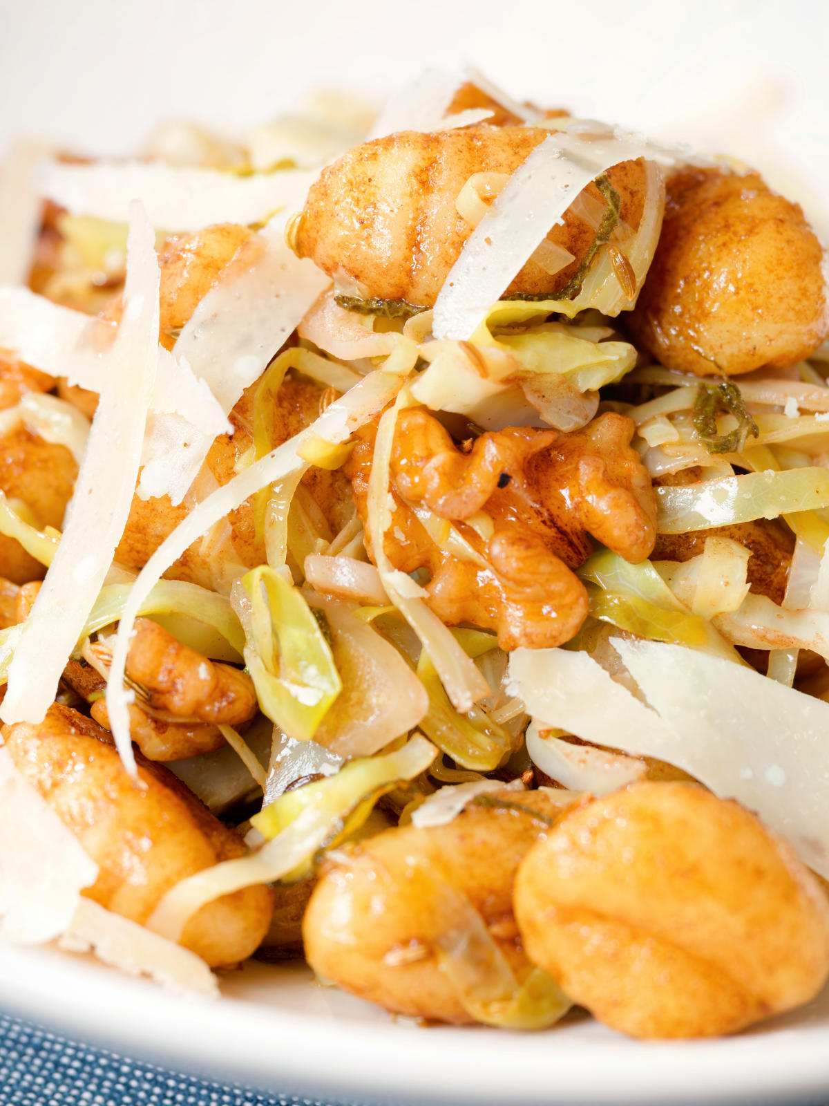 Close-up pan fried cabbage and walnut gnocchi with balsamic vinegar.