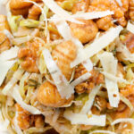 Close-up overhead pan fried cabbage and walnut gnocchi with balsamic vinegar.
