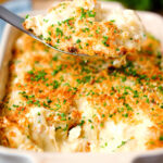 Cheddar cheese and onion baked gnocchi gratin on a spoon.