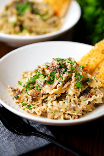Creamy garlic mushroom pasta served with fresh parsley and garlic bread.