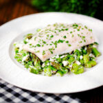 Milk poached smoked haddock fillet served with warm pea and feta salad.