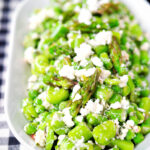 Close-up minted pea and feta salad with asparagus and broad beans.