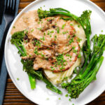 Overhead pork tenderloin with prunes and brandy cream sauce, mashed potato and tenderstem broccoli.
