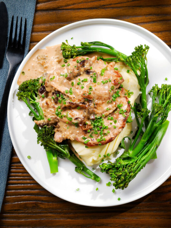 Overhead pork tenderloin with prunes and brandy cream sauce, mashed potato and tenderstem broccoli.