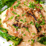Close-up pork tenderloin with prunes and brandy cream sauce, mashed potato and tenderstem broccoli.