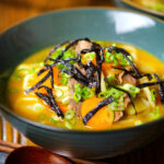 Japanese curry udon soup with beef and vegetables, nori and spring onions.