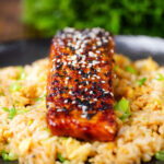 Hoisin sauce glazed salmon fillet topped with sesame seeds served with egg fried rice.