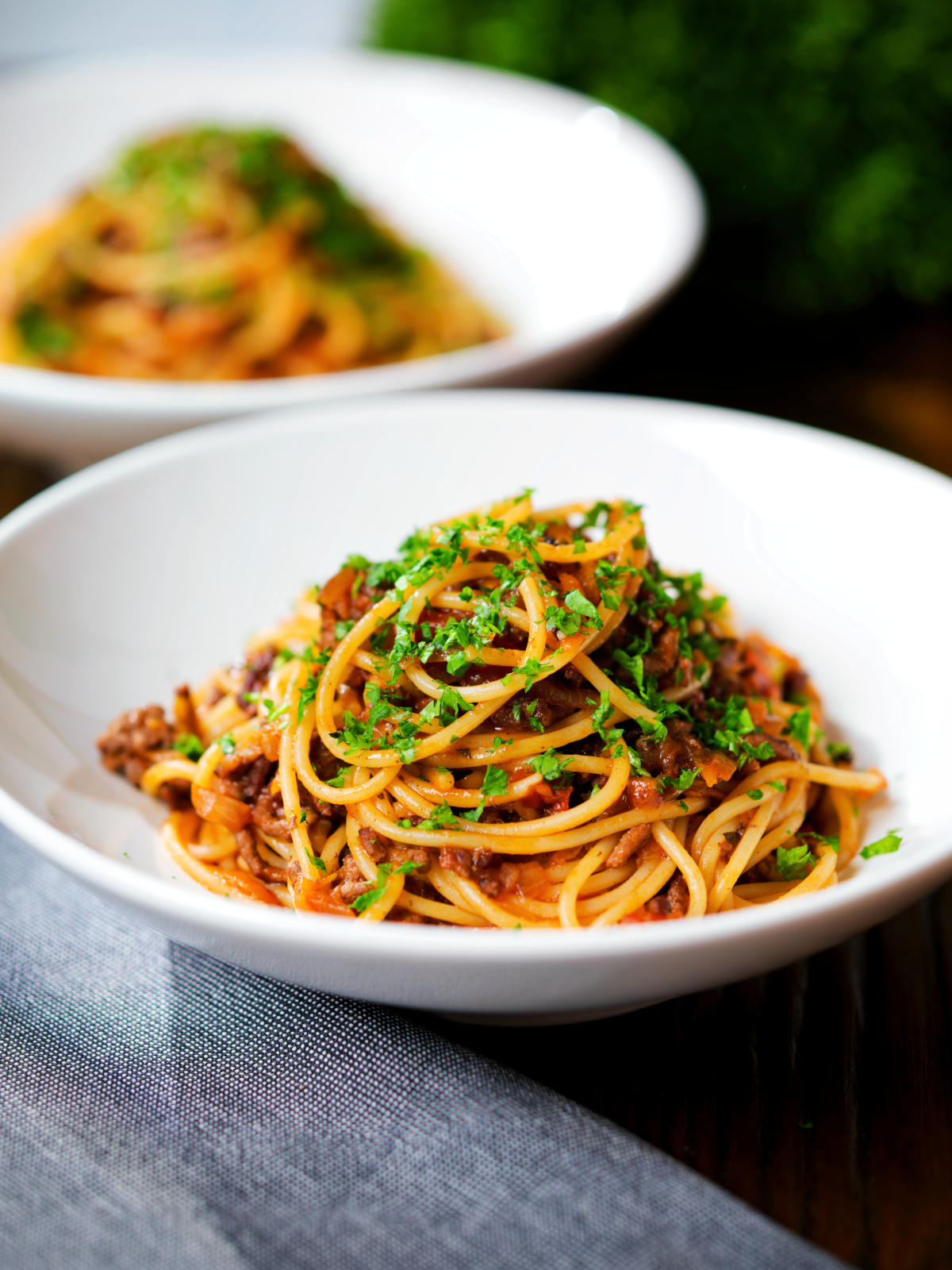 Makaronia me kima (Greek spaghetti bolognese) garnished with fresh parsley.