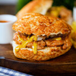 Bifana (Portuguese pork sandwich) served with mustard on a bun.