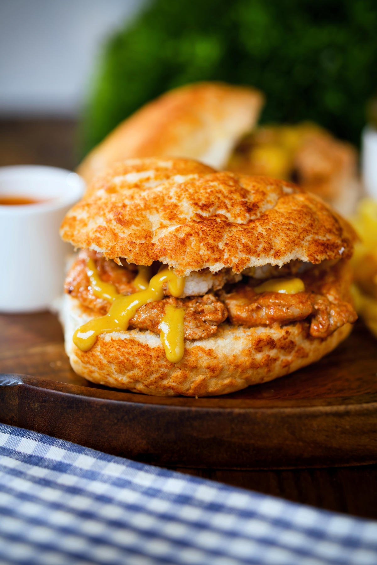 Bifana (Portuguese pork sandwich) served with mustard on a bun.