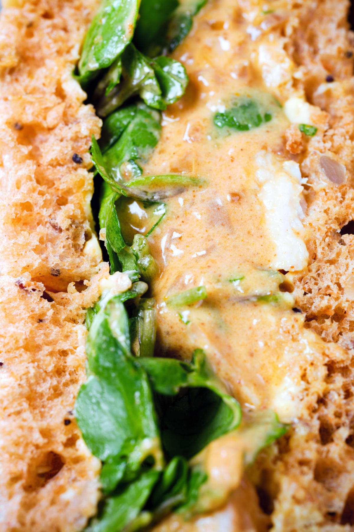 Close-up Coronation chicken sandwich with watercress.