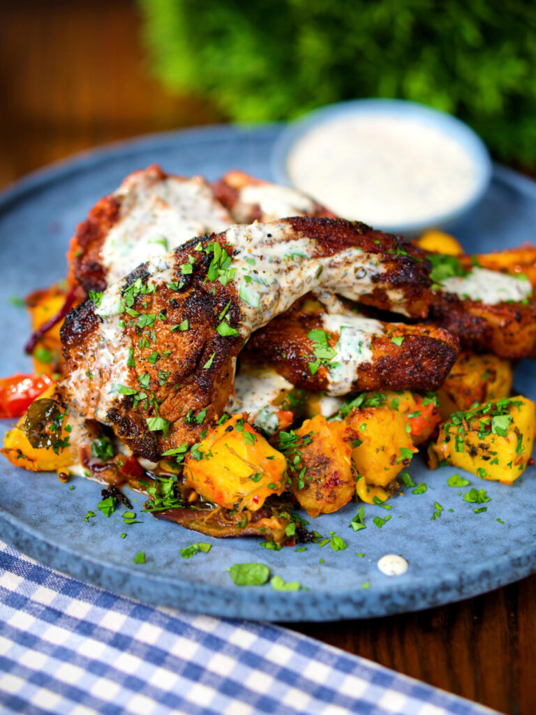 Pan fried Indian masala lamb chops with Bombay potatoes and raita.