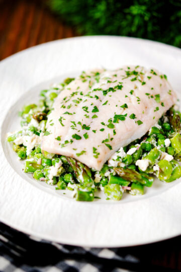 Milk poached smoked haddock served with warm pea and feta salad.
