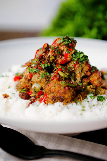 Salt and pepper cauliflower bites with rice, sriracha and coriander.