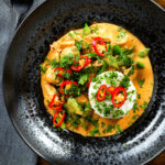 Overhead Thai Panang chicken curry with Jasmine rice, chilli and coriander.