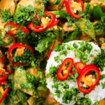 Close-up overhead Thai Panang chicken curry with Jasmine rice, chilli and coriander.