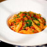 Bloody Mary Pasta (penne alla vodka), served in a white bowl.