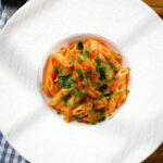 Overhead Bloody Mary Pasta (penne alla vodka), served in a white bowl.
