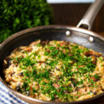 One-pot stilton cheese and mushroom orzo with sage in a pan.