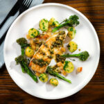 Pan fried halibut steak with Grenobloise sauce, buttered potatoes and roasted tenderstem broccoli.