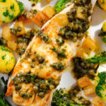 Overhead close-up pan-fried halibut with Grenobloise sauce, buttered potatoes and tenderstem broccoli.