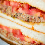 Close-up tomato and sardine salad sandwich.