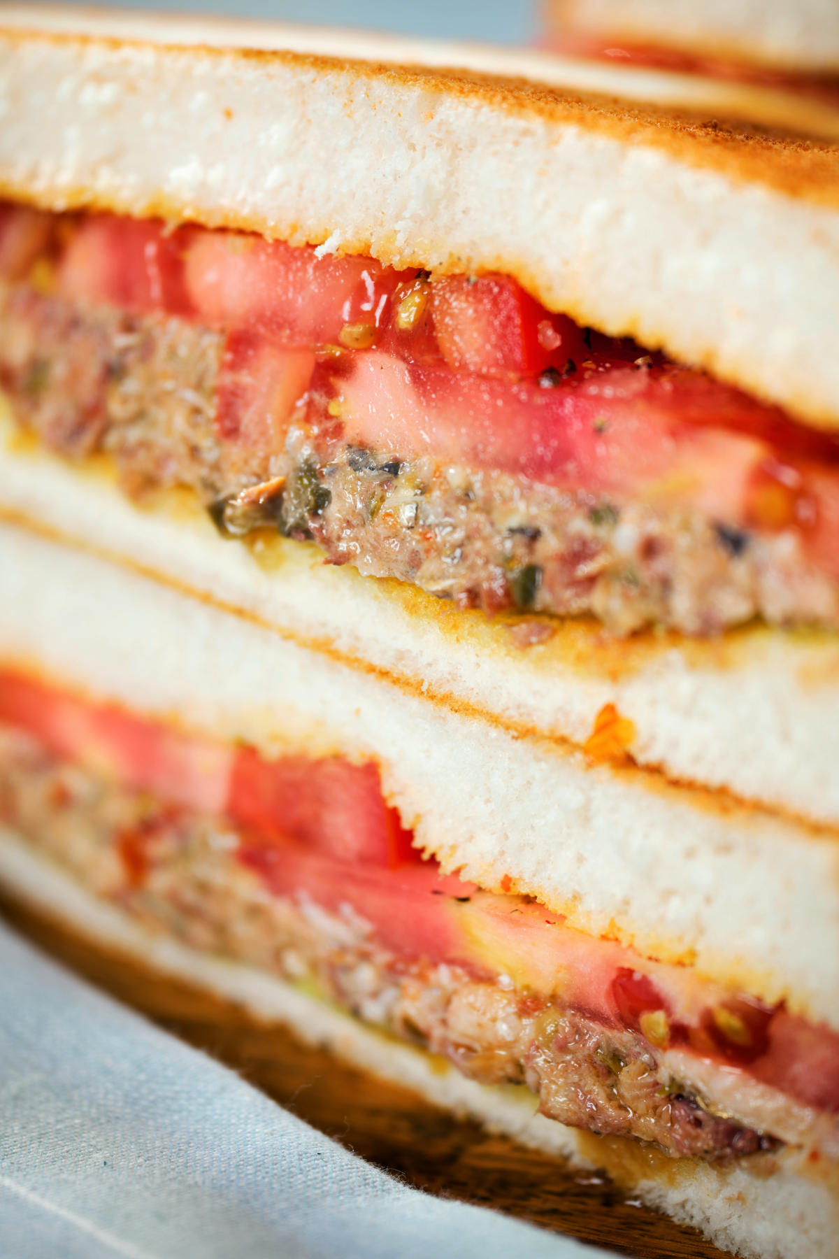 Close-up tomato and sardine salad sandwich.